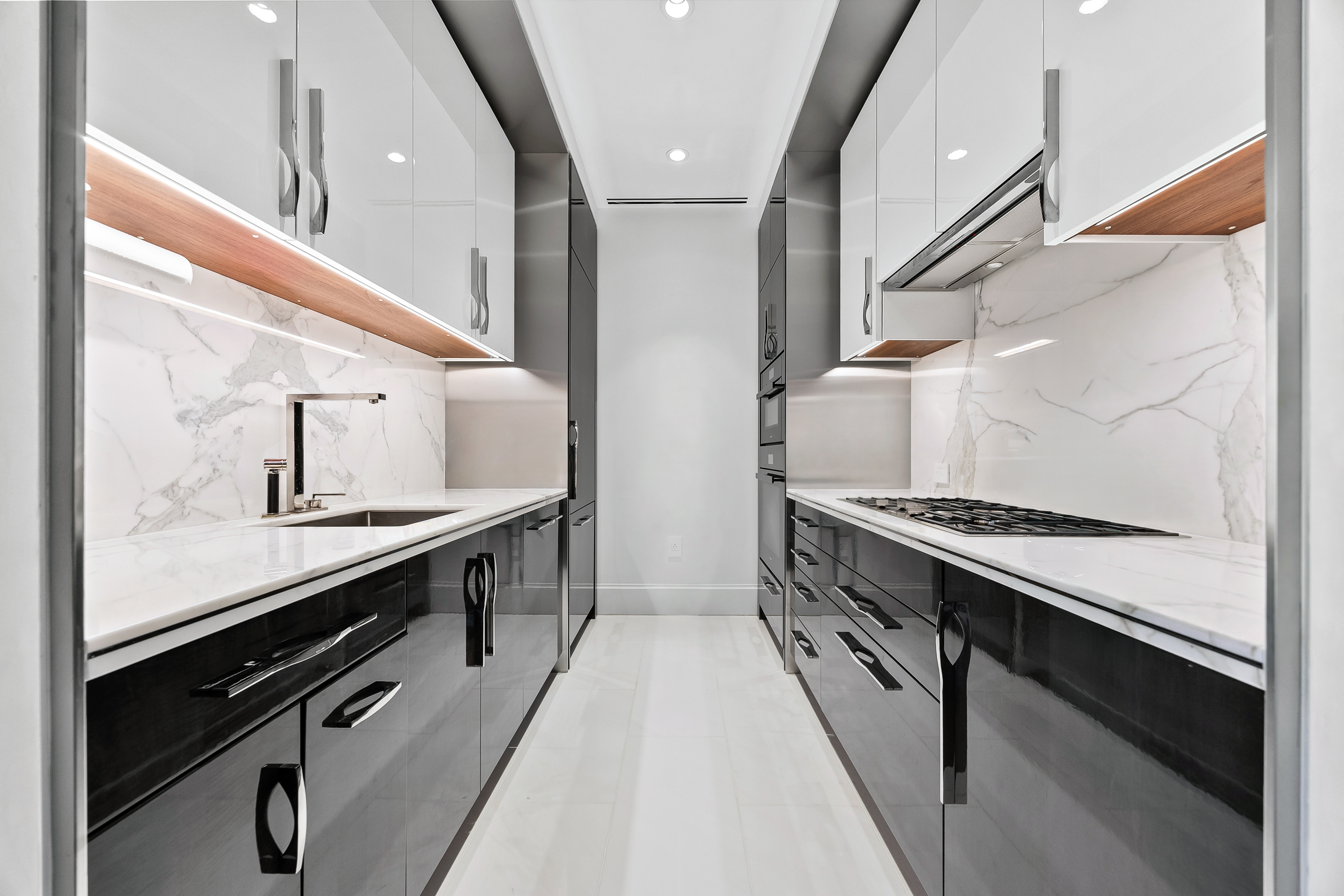 217 West 57th Street, Unit 36D Manhattan, NY 10019 - Photo 4 of 26 a kitchen with granite countertop a stove oven and sink
