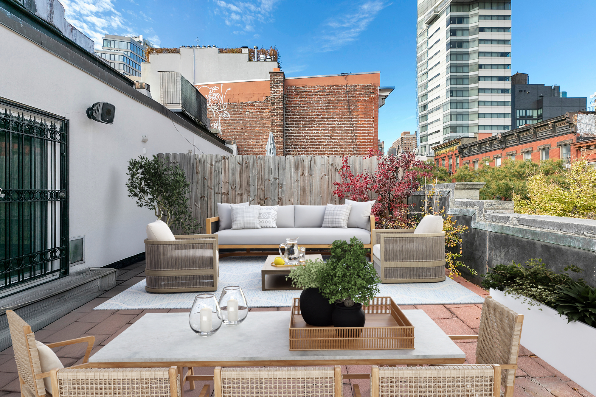 220 East 5th Street, Unit PHE Manhattan, NY 10003 - Photo 3 of 11 a view of a patio with couches and a potted plant on a table