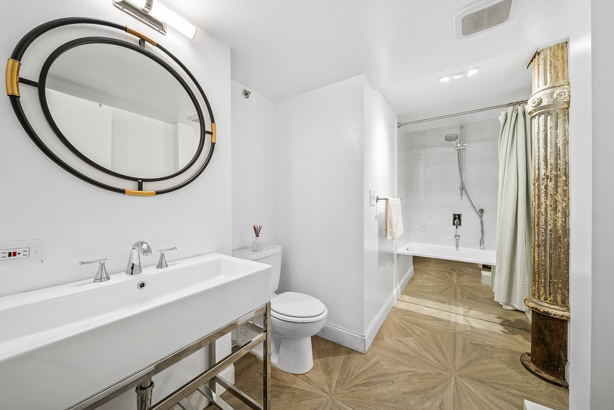 121 West 20th Street, Unit 3C Manhattan, NY 10011 - Photo 9 of 10 a bathroom with a sink a toilet and a mirror