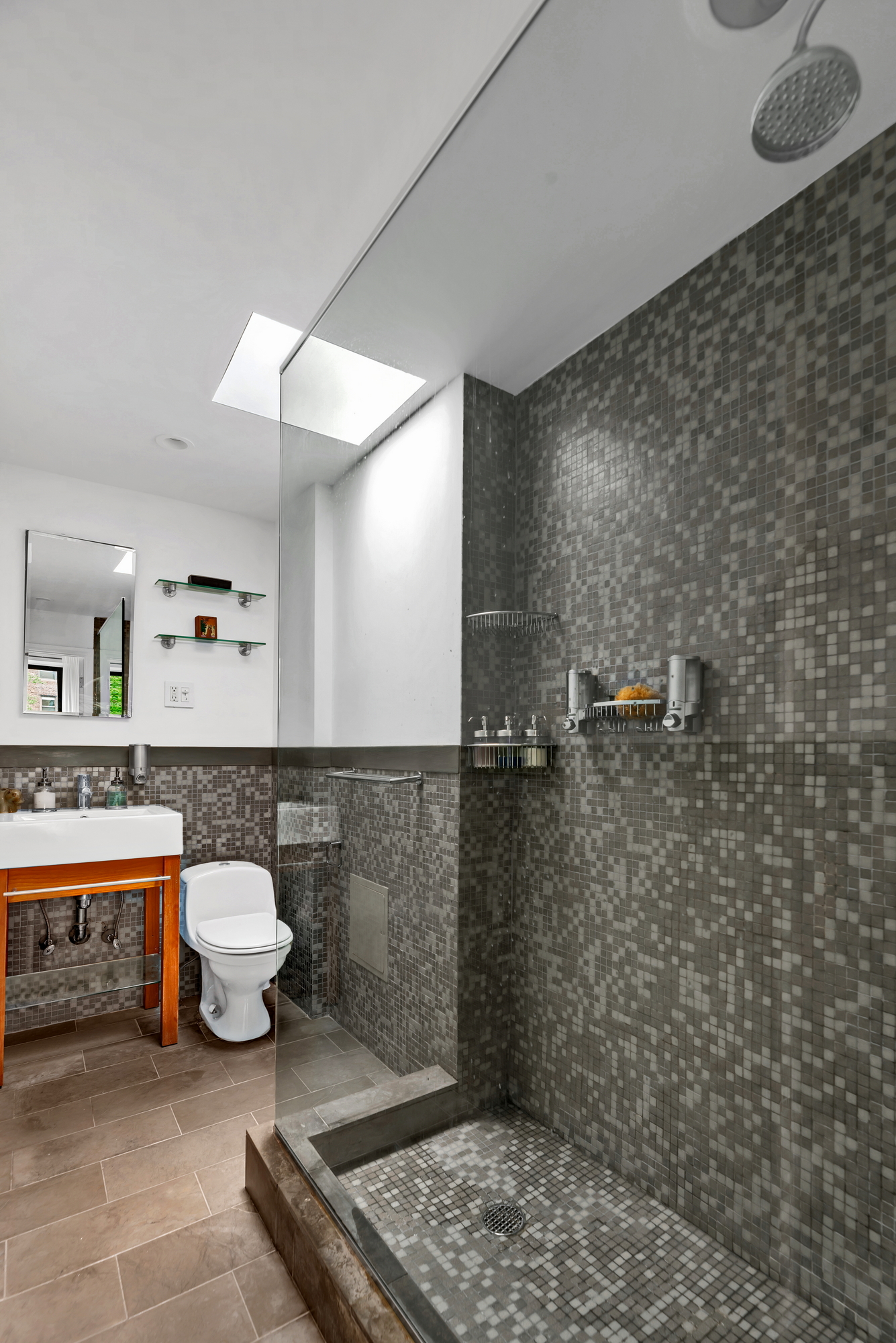 72 East 93rd Street, Unit 5 Manhattan, NY 10128 - Photo 12 of 17 a bathroom with a toilet a sink and mirror