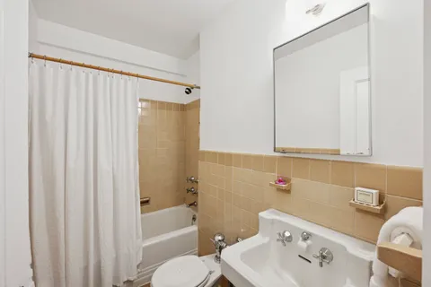 a bathroom with a sink a toilet and bathtub
