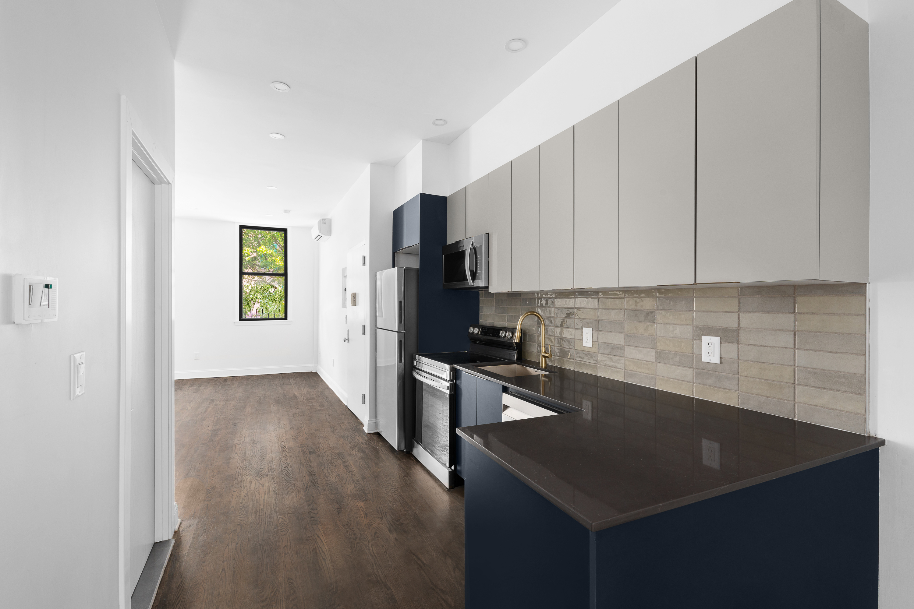 92 Wilson Avenue Brooklyn, NY 11237 - Photo 3 of 15 a kitchen with a sink a stove and cabinets