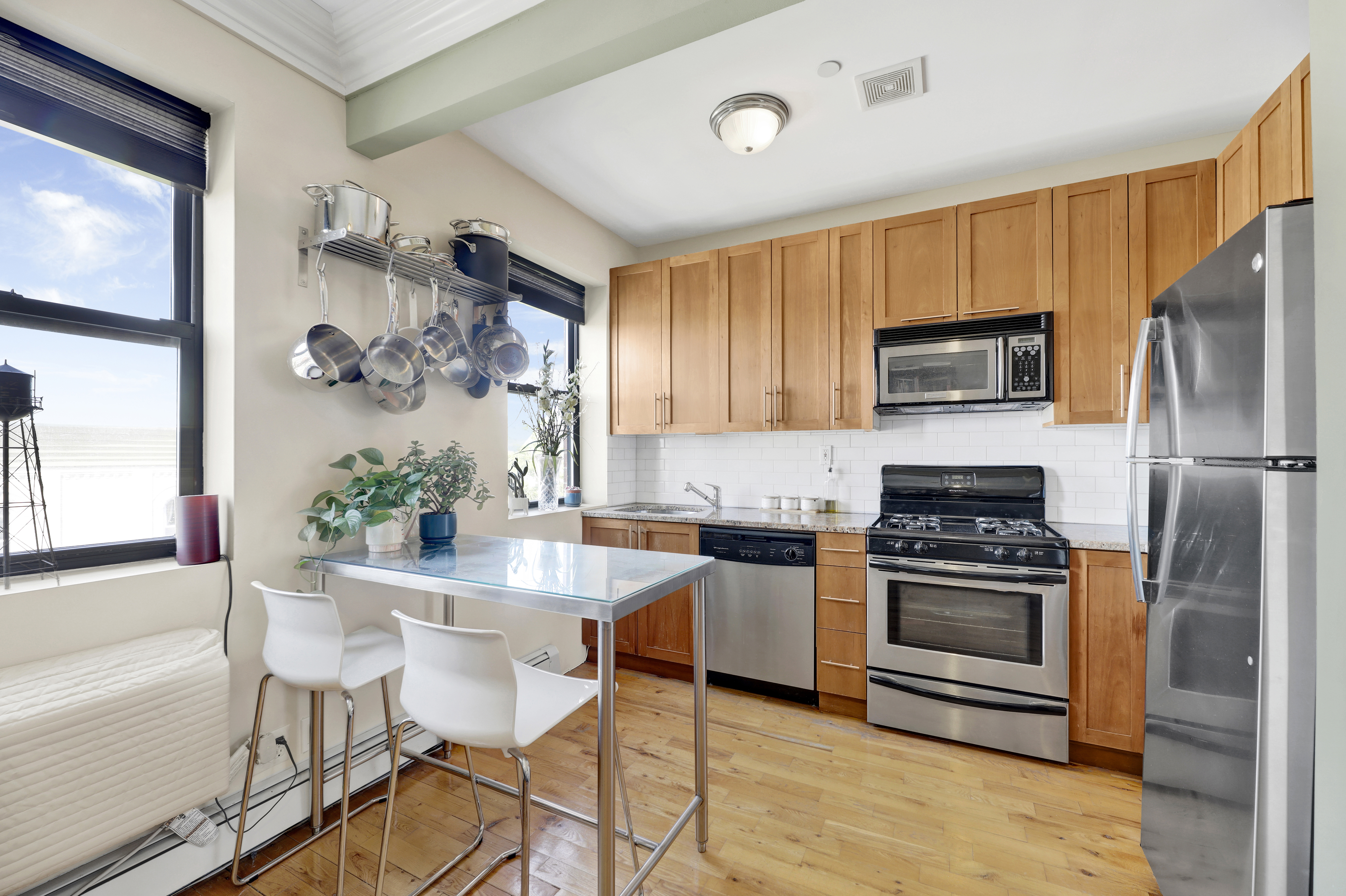 36 Russell Street, Unit 22 Brooklyn, NY 11222 - Photo 13 of 27 a kitchen with granite countertop a stove a sink cabinets and stainless steel appliances