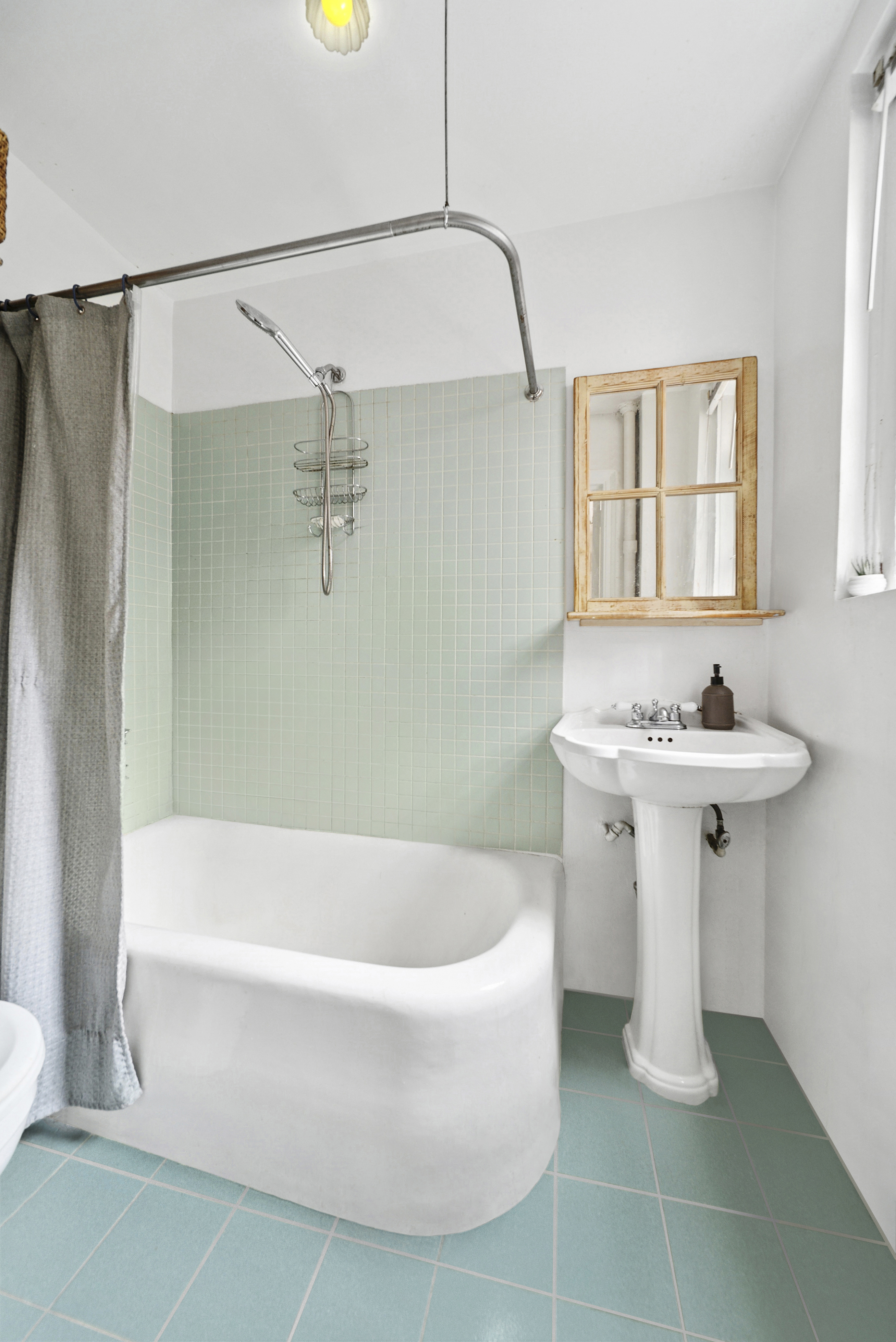 321 East 54th Street, Unit 6J Manhattan, NY 10022 - Photo 4 of 9 a bathroom with a sink a mirror and a shower