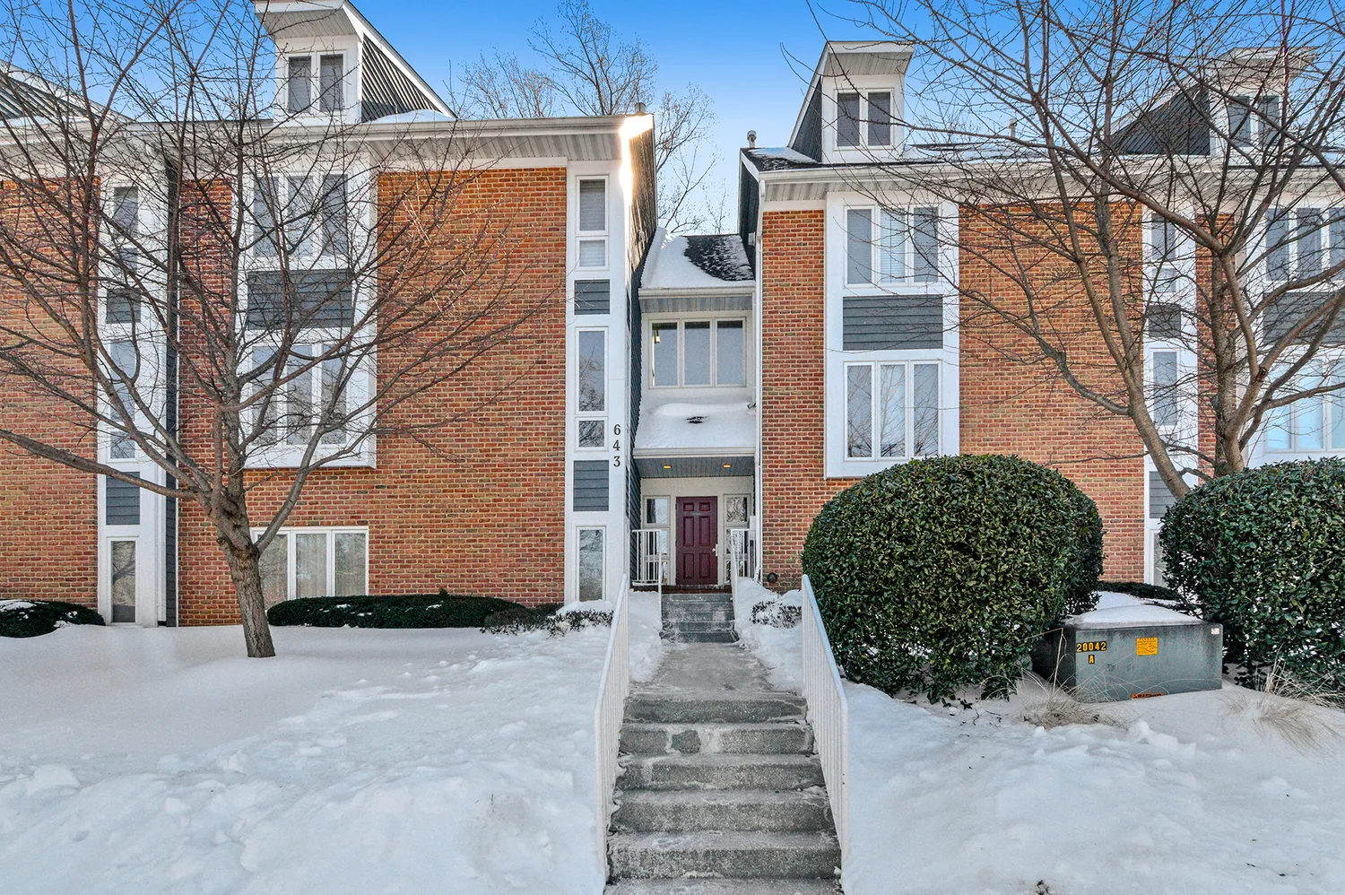 a view of a house with a yard and large tree
