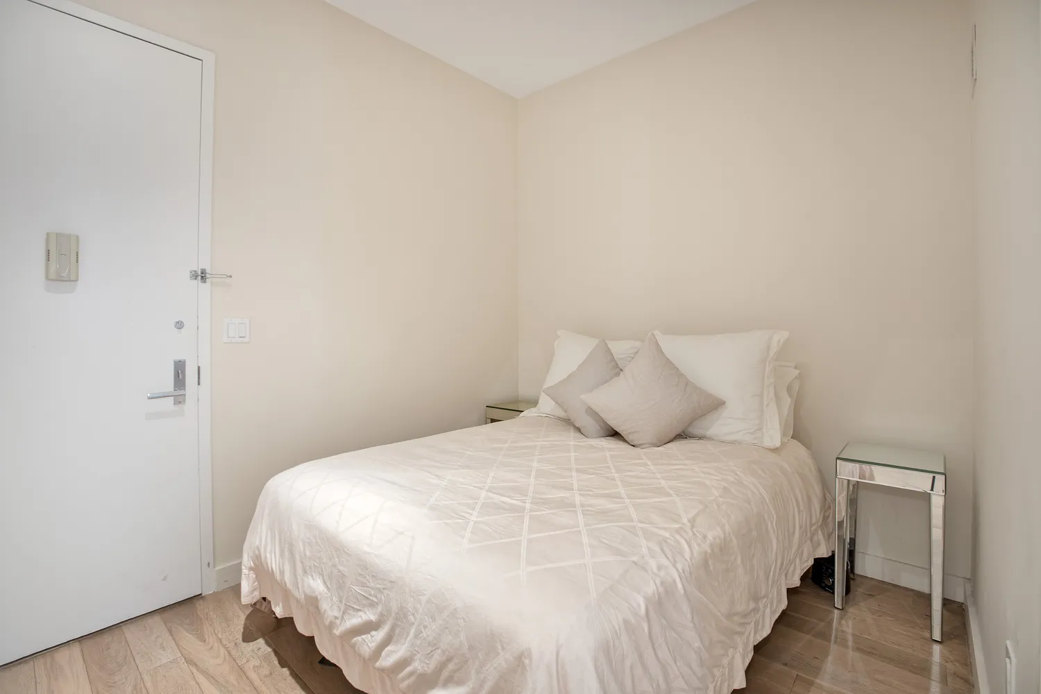 a large bed sitting in a bedroom next to a bathroom