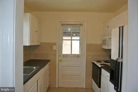 a kitchen with a sink and a stove top oven