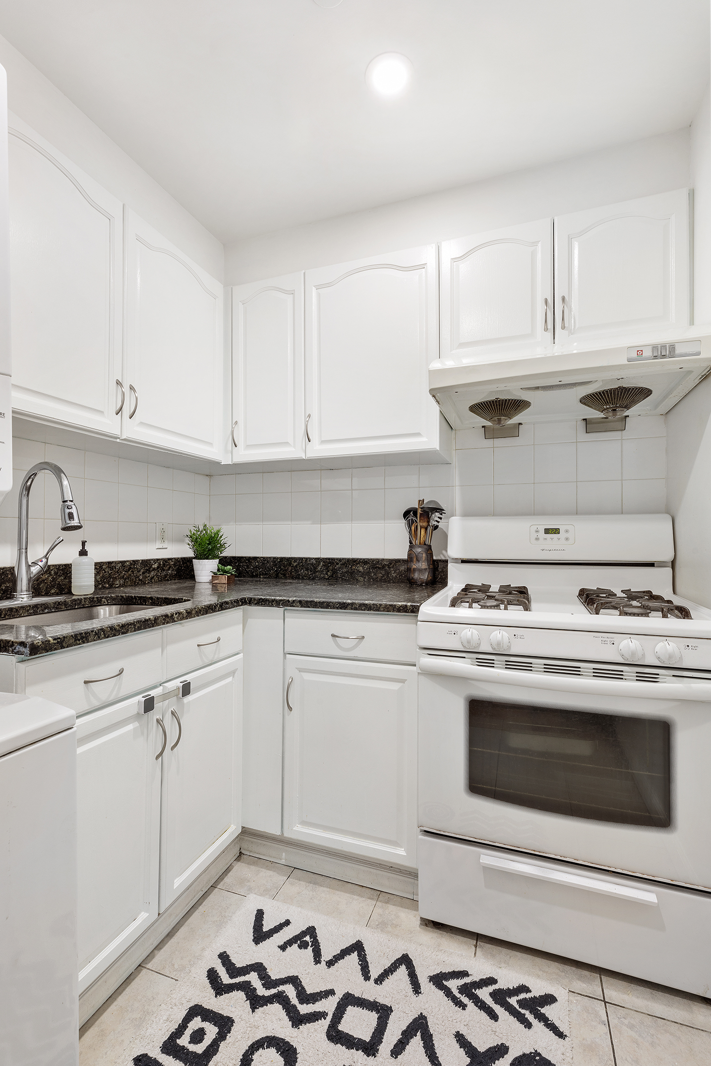 97 Moore Street, Unit 4B Brooklyn, NY 11206 - Photo 3 of 8 a stove top oven sitting inside of a kitchen