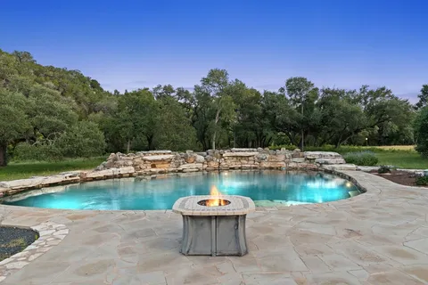 a view of a backyard with swimming pool