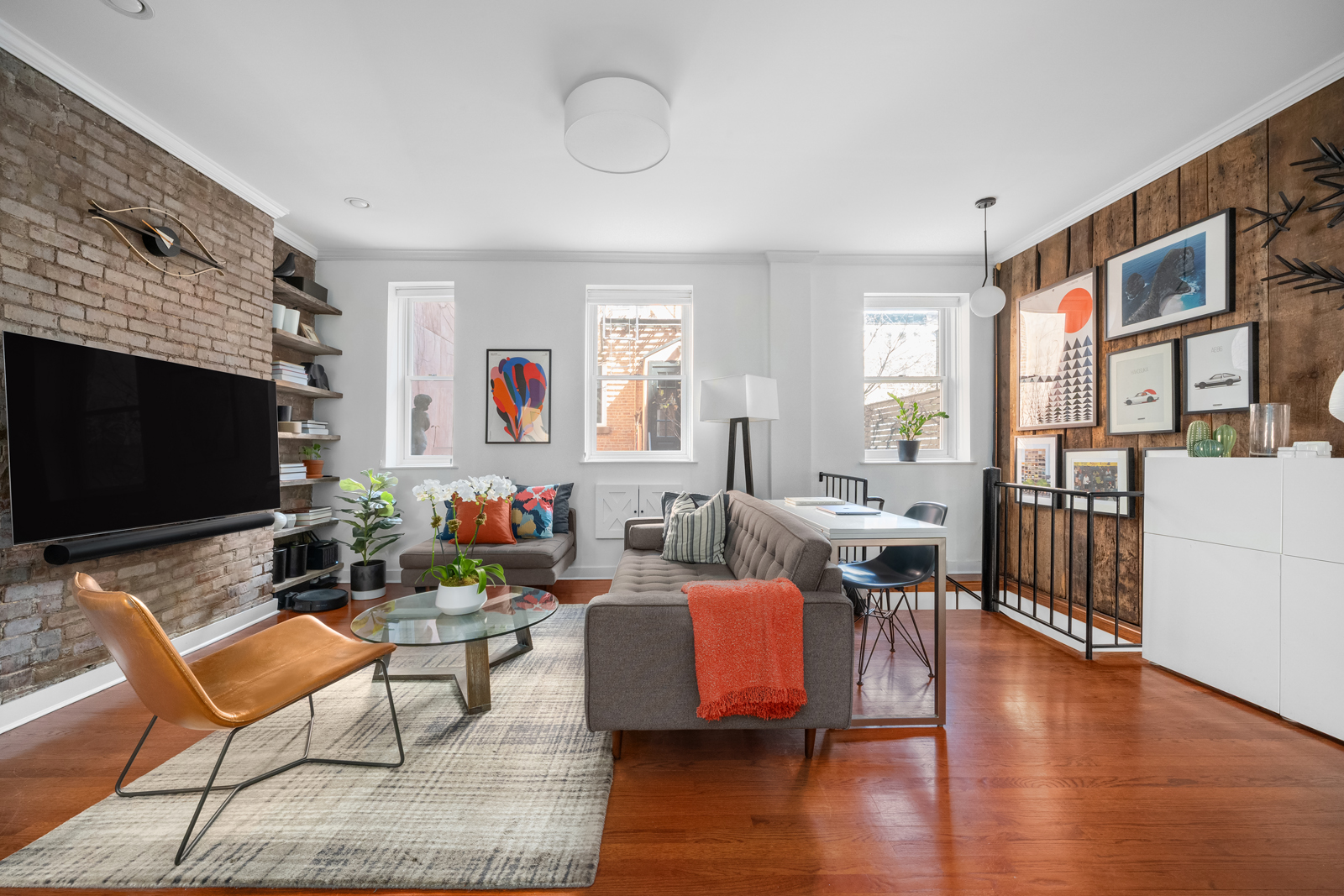 337 West 20th Street, Unit 1B Manhattan, NY 10011 - Photo 7 of 11 a living room with furniture wooden floor and a flat screen tv