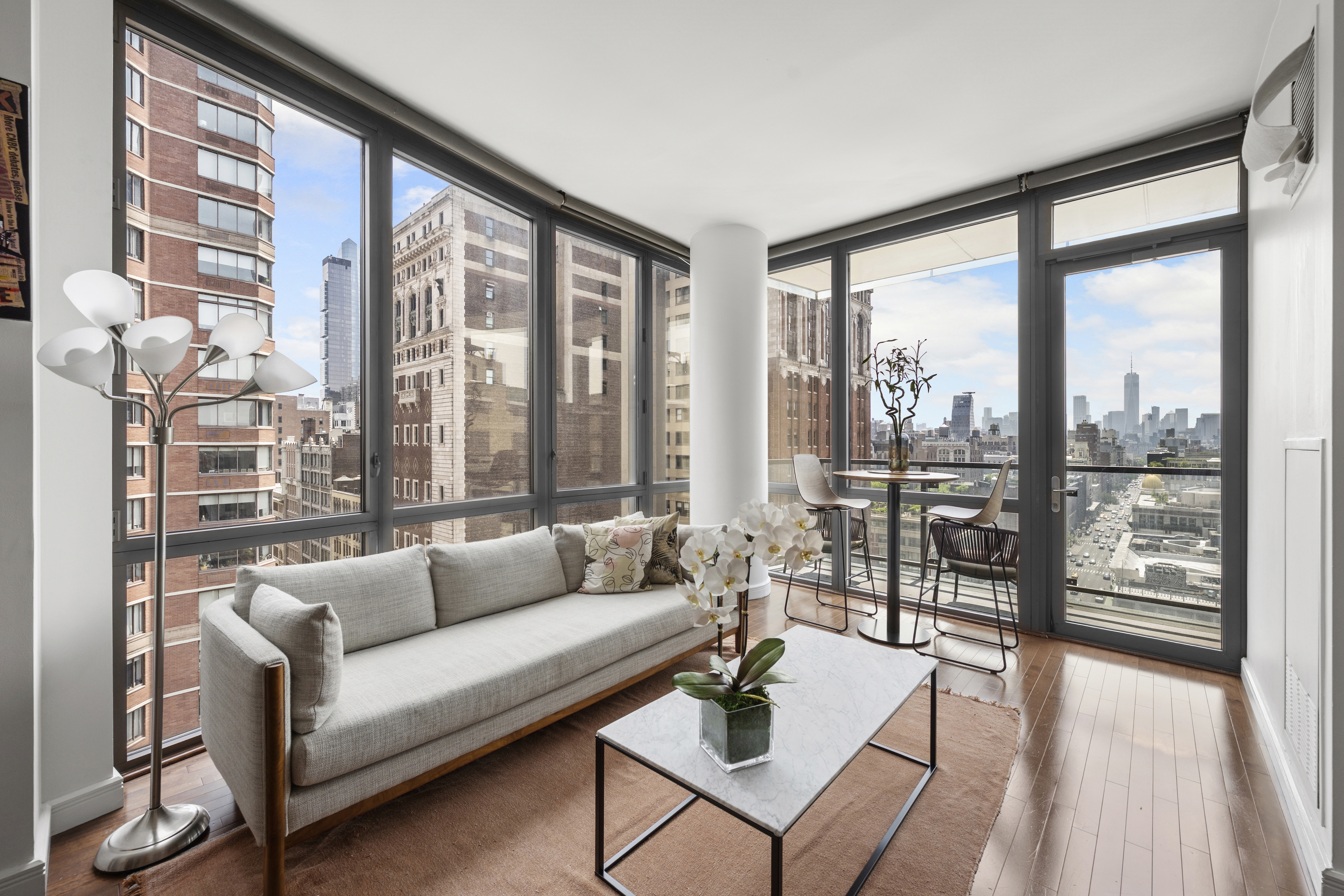 a living room with furniture and a floor to ceiling window