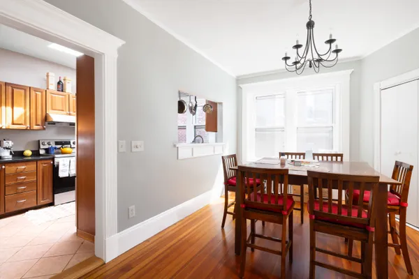 a view of a dining room with furniture window and wooden floor