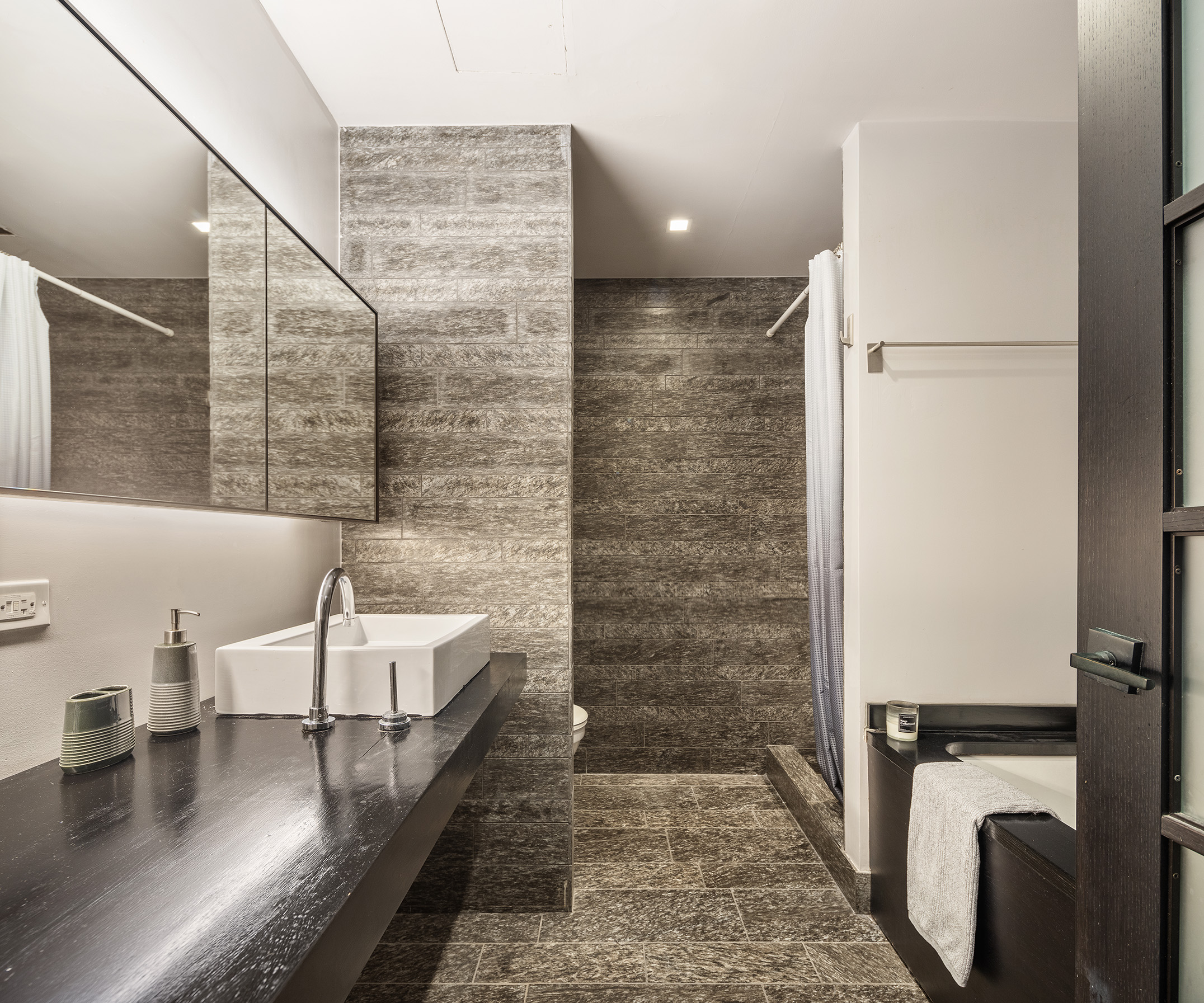 20 Pine Street, Unit 2413 Manhattan, NY 10005 - Photo 7 of 16 a bathroom with a sink and a mirror