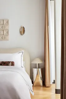 a bedroom with a bed and a night stand