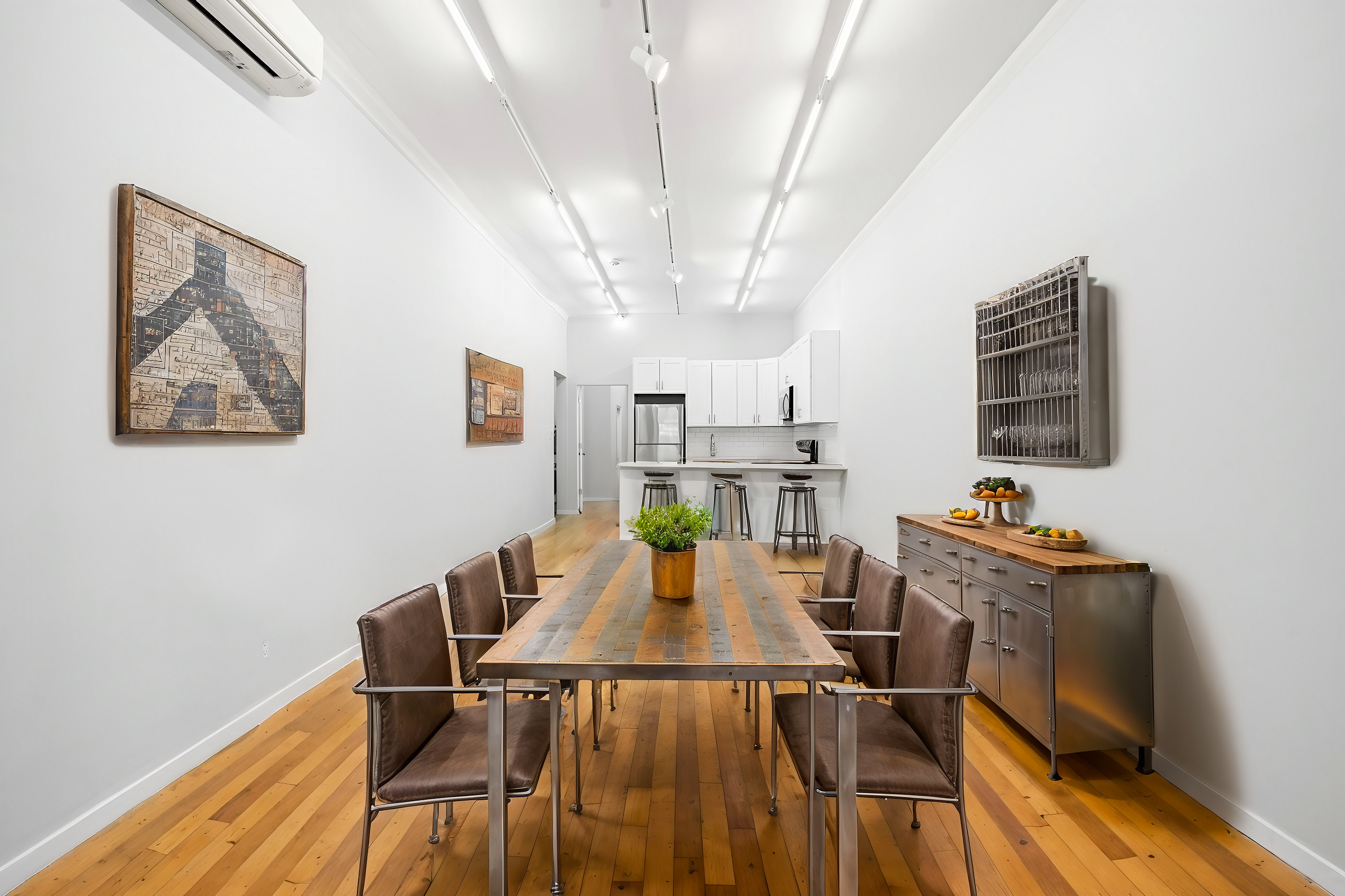 249 East Houston Street, Unit PARLOR Manhattan, NY 10002 - Photo 3 of 12 a view of a dining room with furniture and wooden floor