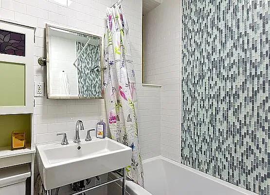 138 Edgecombe Avenue, Unit 3A Manhattan, NY 10030 - Photo 5 of 10 a bathroom with a sink a mirror and a shower