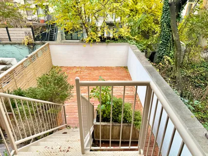 a view of balcony with wooden floor and fence