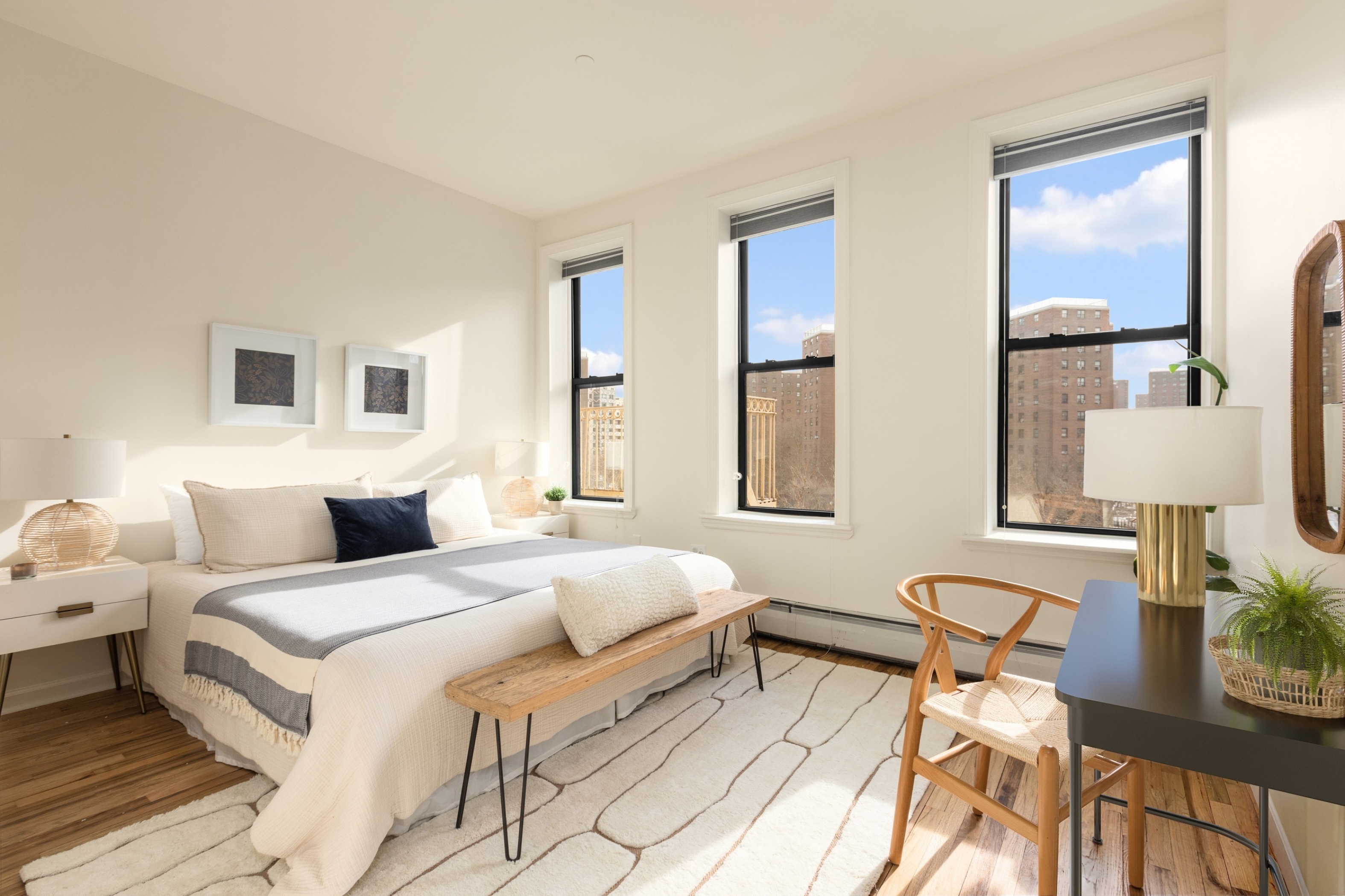 61 Lenox Avenue, Unit 5D Manhattan, NY 10026 - Photo 8 of 14 a bedroom with a bed and wooden floor