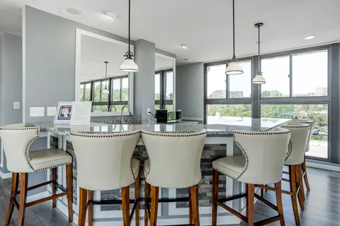 a kitchen with a table chairs stove and cabinets