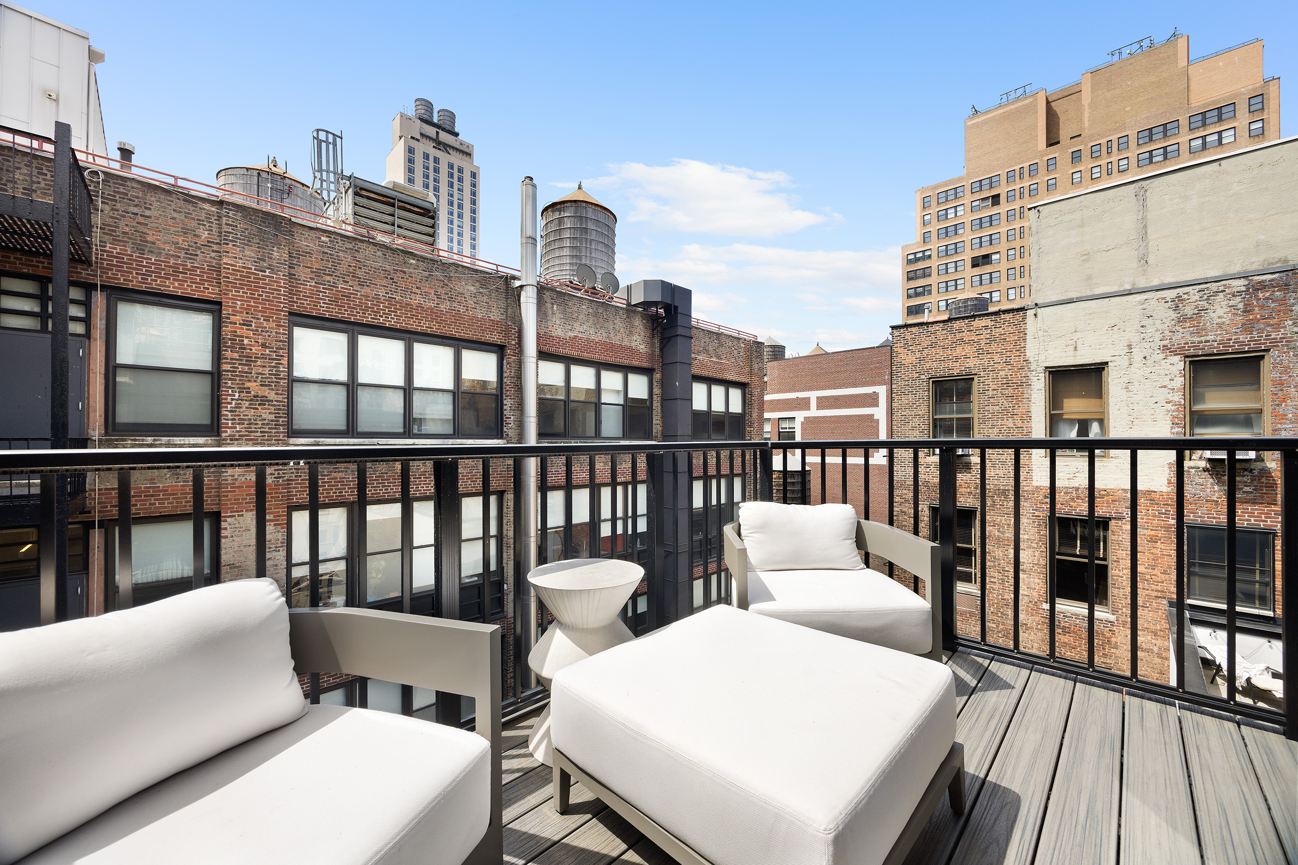 128 West 26th Street, Unit PH Manhattan, NY 10001 - Photo 15 of 21 a view of a balcony with two chairs and a potted plant