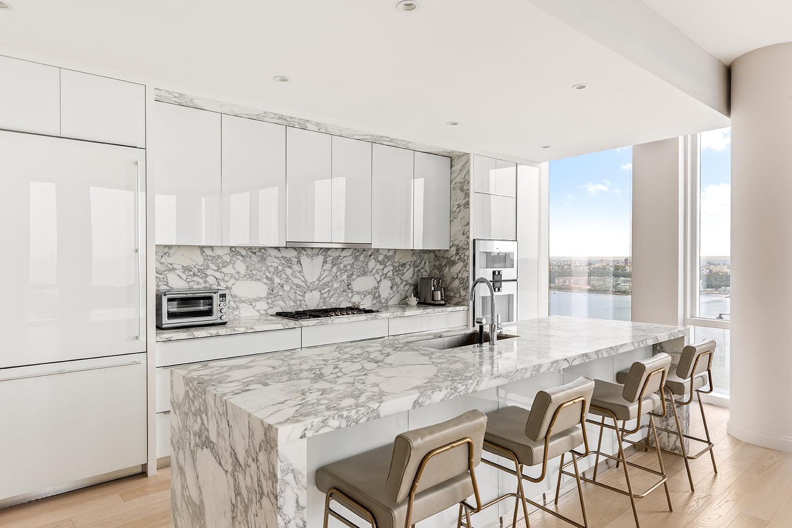 10 Riverside Boulevard, Unit 30B Manhattan, NY 10069 - Photo 3 of 19 a kitchen with stainless steel appliances kitchen island granite countertop a refrigerator and cabinets