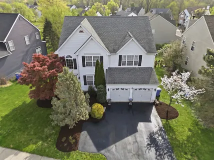 a front view of a house with a yard and a garden