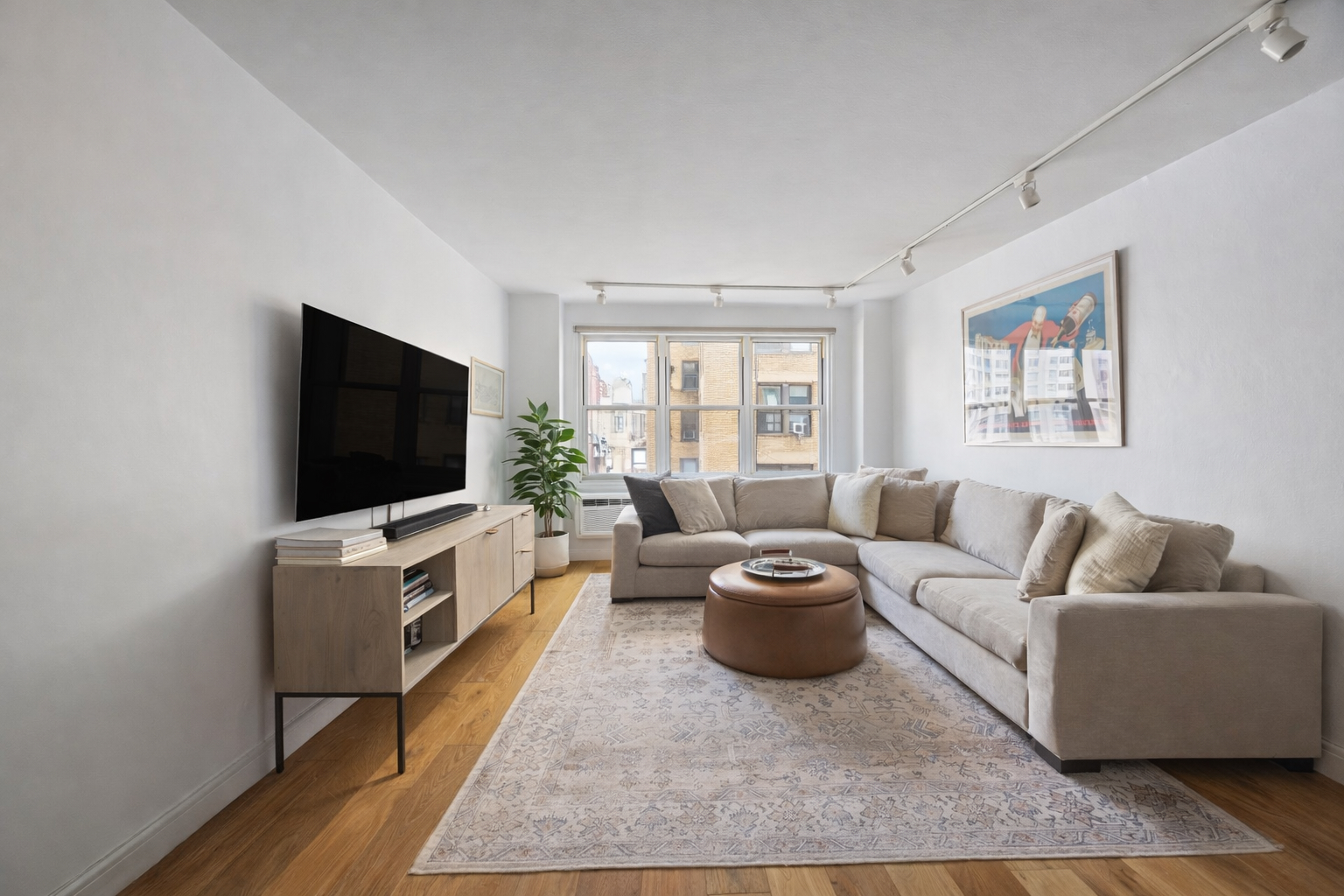 415 East 85th Street, Unit 7J Manhattan, NY 10028 - Photo 1 of 9 a living room with furniture and a flat screen tv
