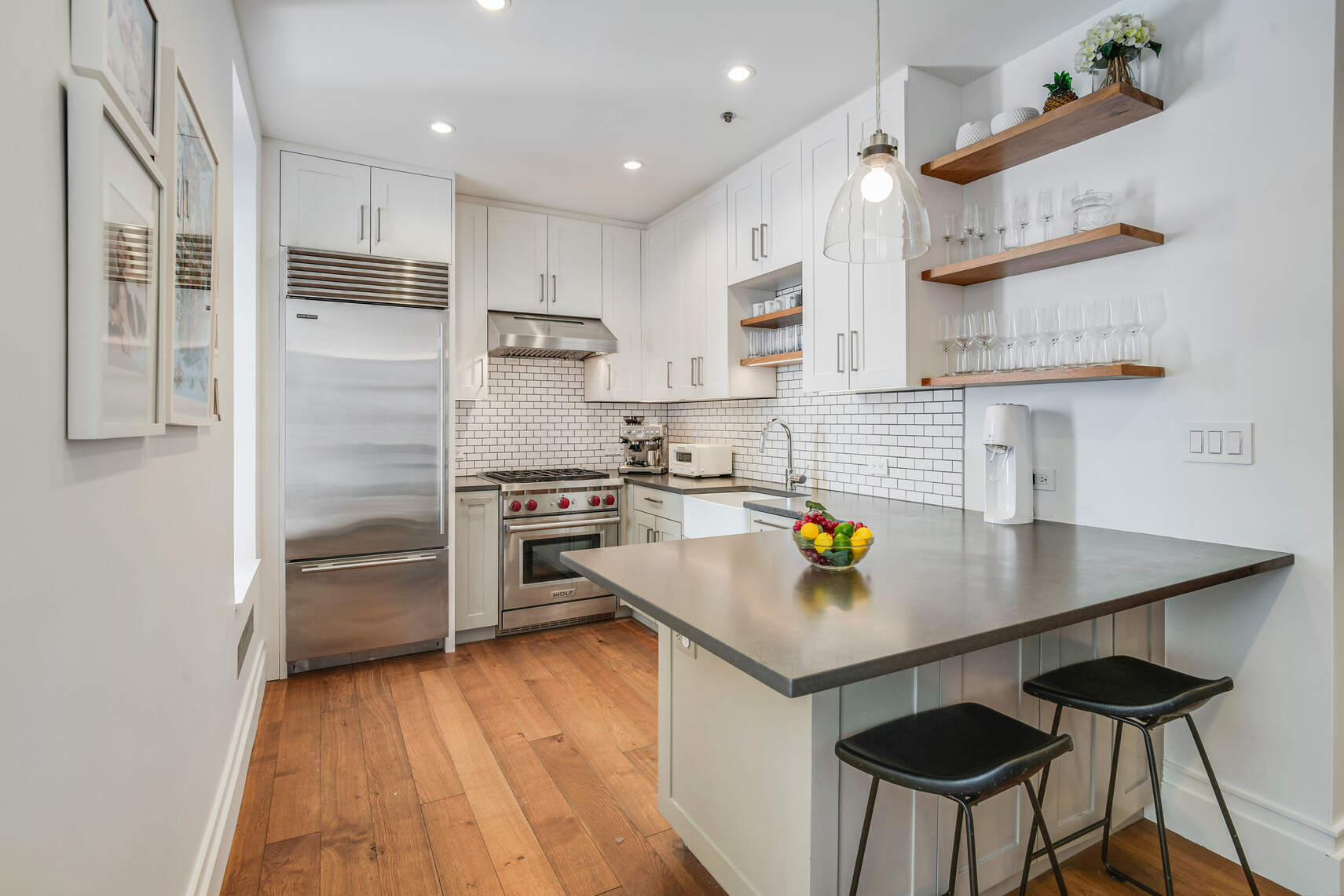 60 Pineapple Street, Unit 7I Brooklyn, NY 11201 - Photo 5 of 14 a kitchen with stainless steel appliances a stove refrigerator sink and cabinets