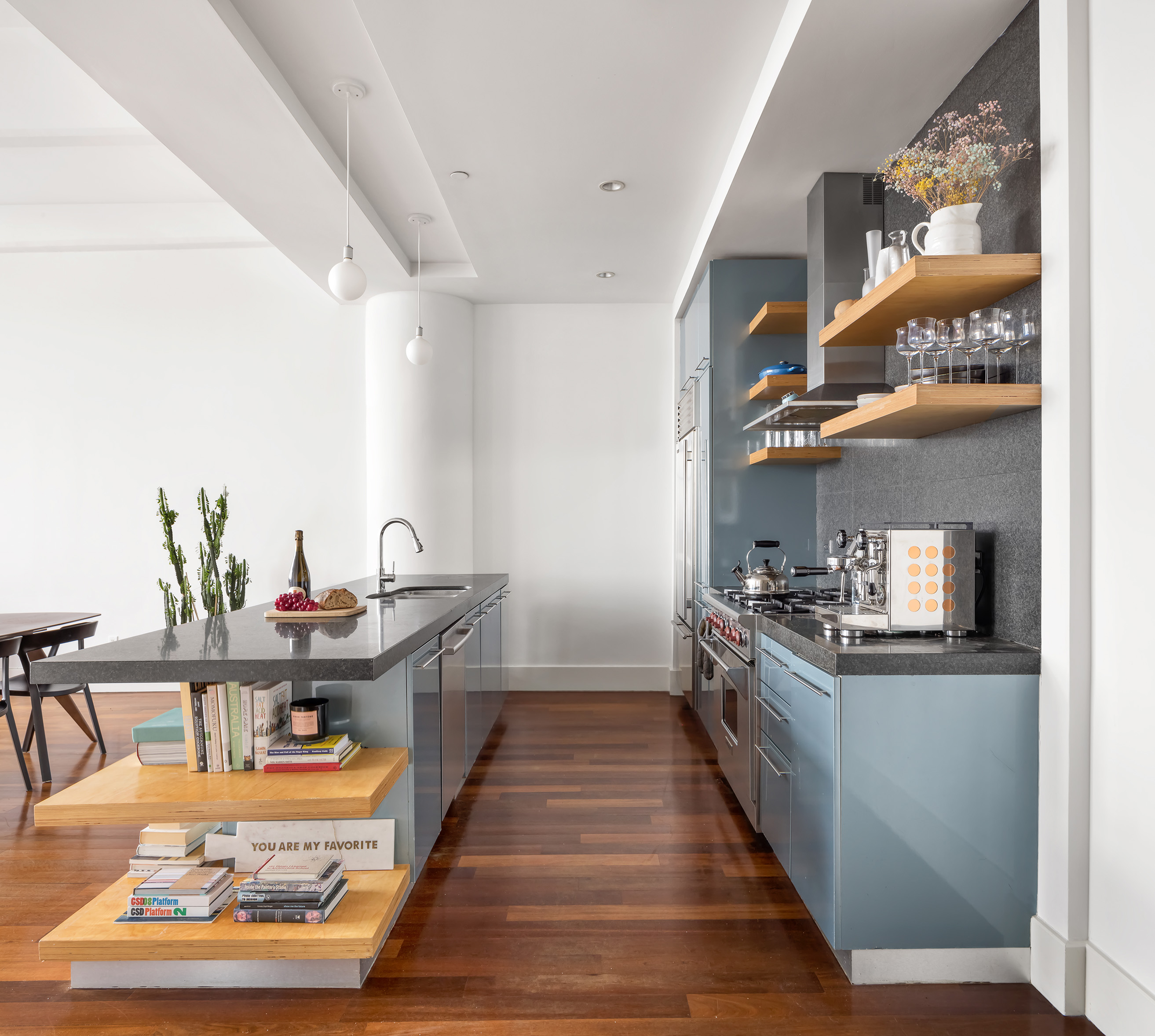60 Broadway, Unit 6H Brooklyn, NY 11249 - Photo 4 of 16 a kitchen with stainless steel appliances granite countertop a sink stove and wooden cabinets