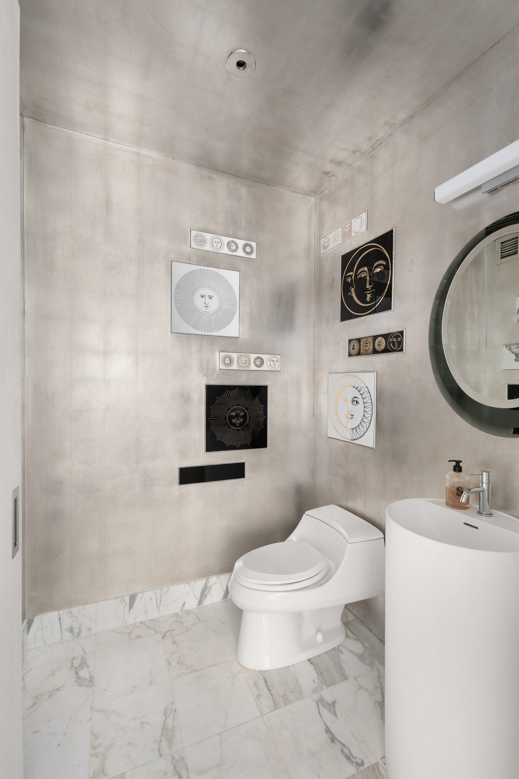 10 West End Avenue, Unit 4B Manhattan, NY 10023 - Photo 9 of 12 a bathroom with a toilet sink a mirror and vanity