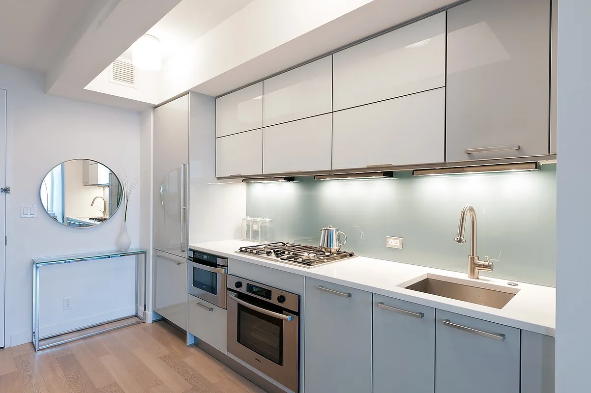 22 North 6th Street, Unit 23E Brooklyn, NY 11249 - Photo 3 of 10 a kitchen with a stove and a microwave