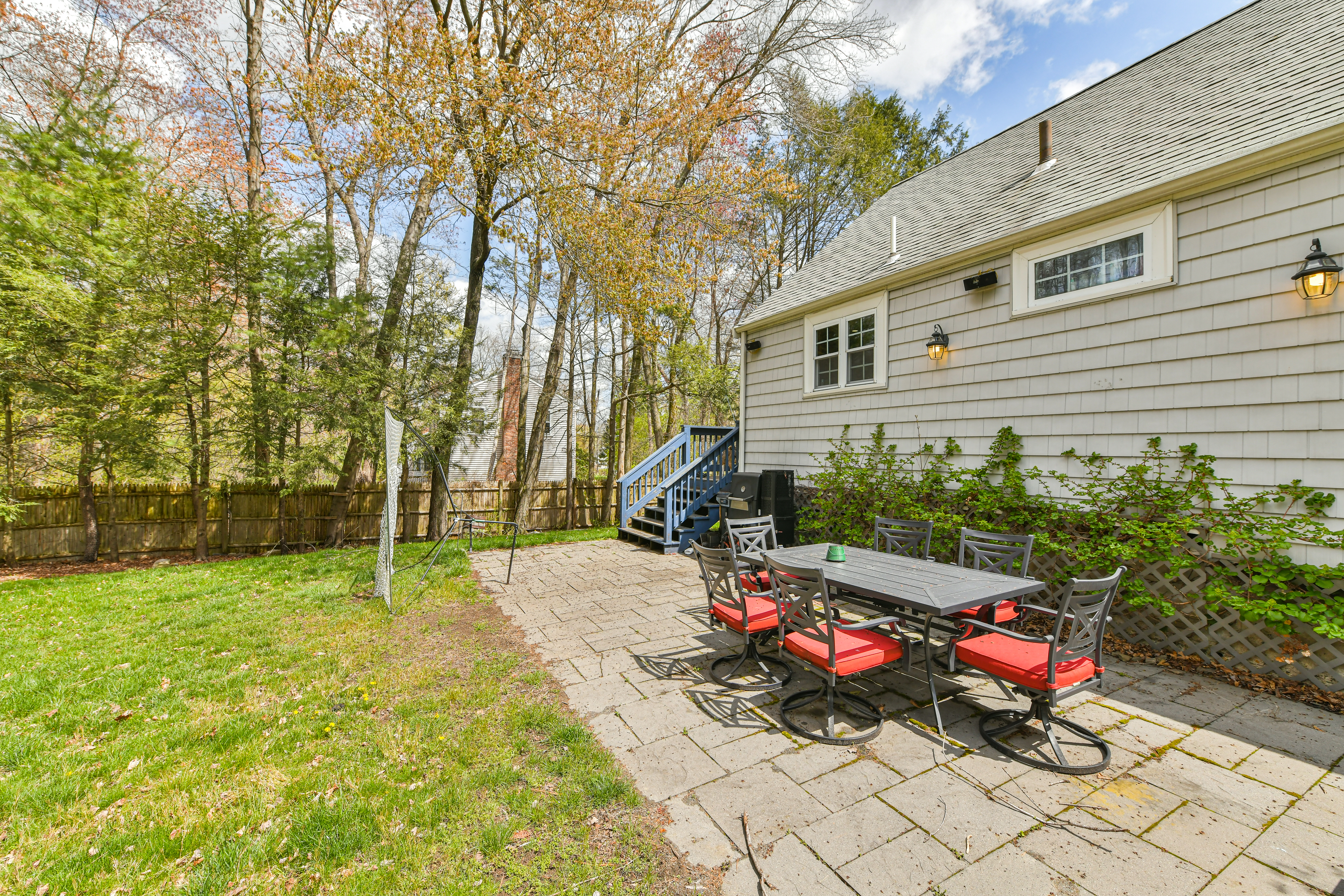 50 Rustic Road Walpole, MA 02032 - Photo 13 of 16 a backyard of a house with fire pit and chairs