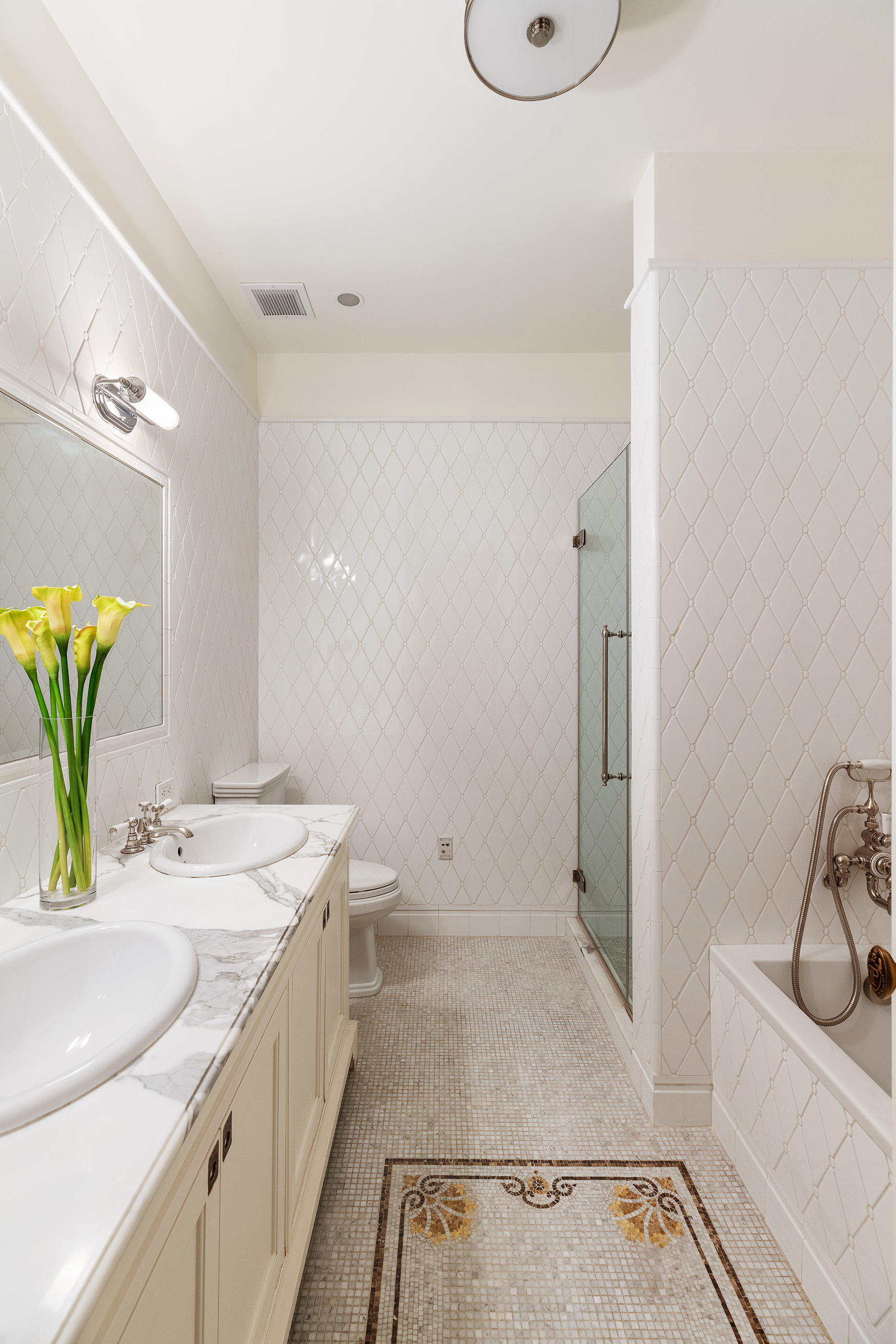 1 Central Park South, Unit 802 Manhattan, NY 10019 - Photo 5 of 16 a bathroom with a sink a toilet and mirror