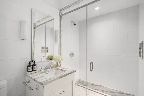 a bathroom with a sink toilet and shower