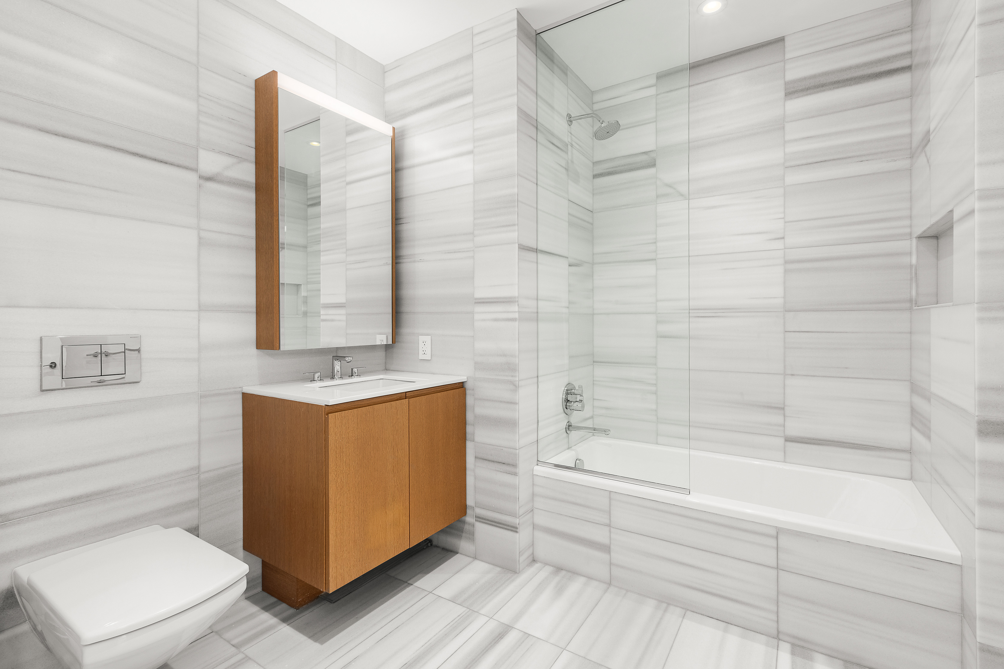 50 West Street, Unit 14B Manhattan, NY 10006 - Photo 12 of 29 a bathroom with a sink a toilet and shower