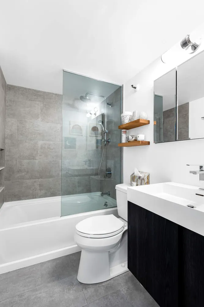 a bathroom with a sink a toilet and shower