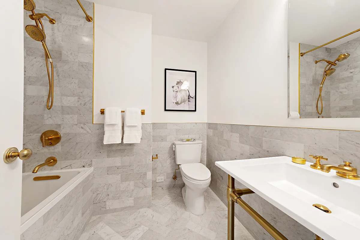 2 5th Avenue, Unit PHC Manhattan, NY 10011 - Photo 9 of 13 a bathroom with a sink a toilet and shower