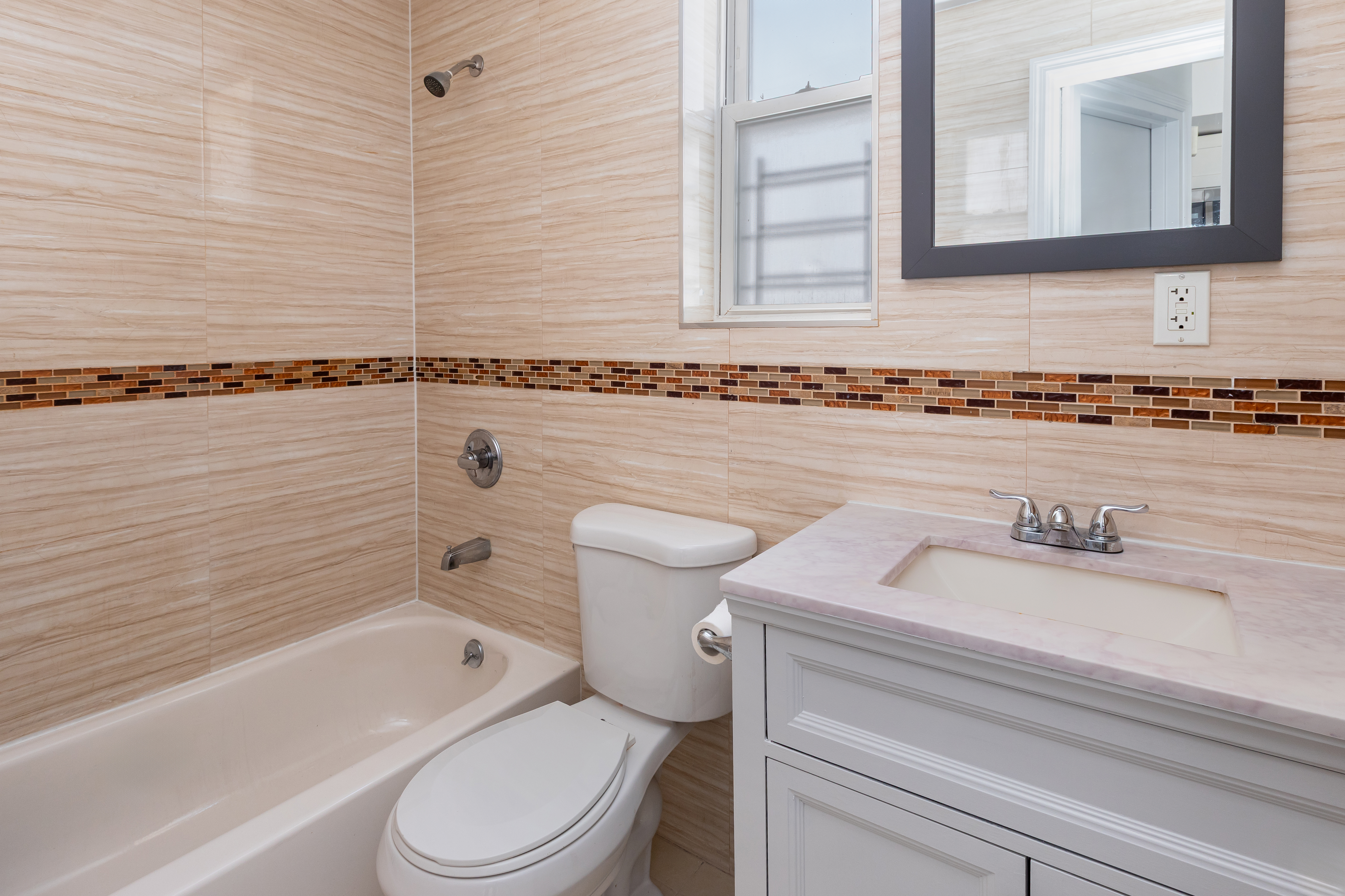 1030 Winthrop Street, Unit 2A Brooklyn, NY 11212 - Photo 7 of 10 a bathroom with a granite countertop toilet sink and mirror