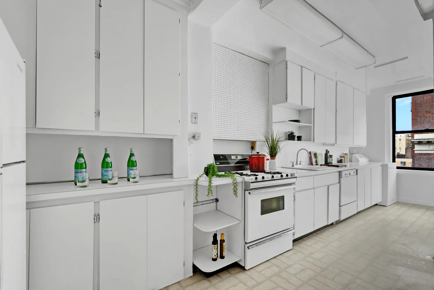 a kitchen with white cabinets and white appliances