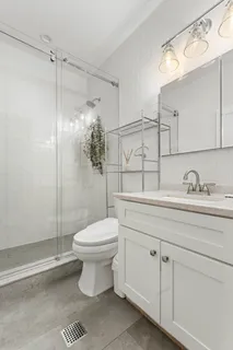 a bathroom with a sink toilet and shower