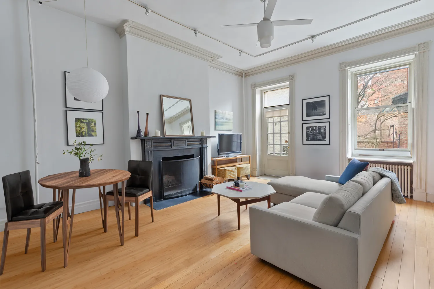 a living room with furniture a fireplace and a window