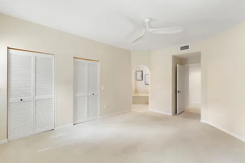 a bathroom with a granite countertop sink a mirror and shower