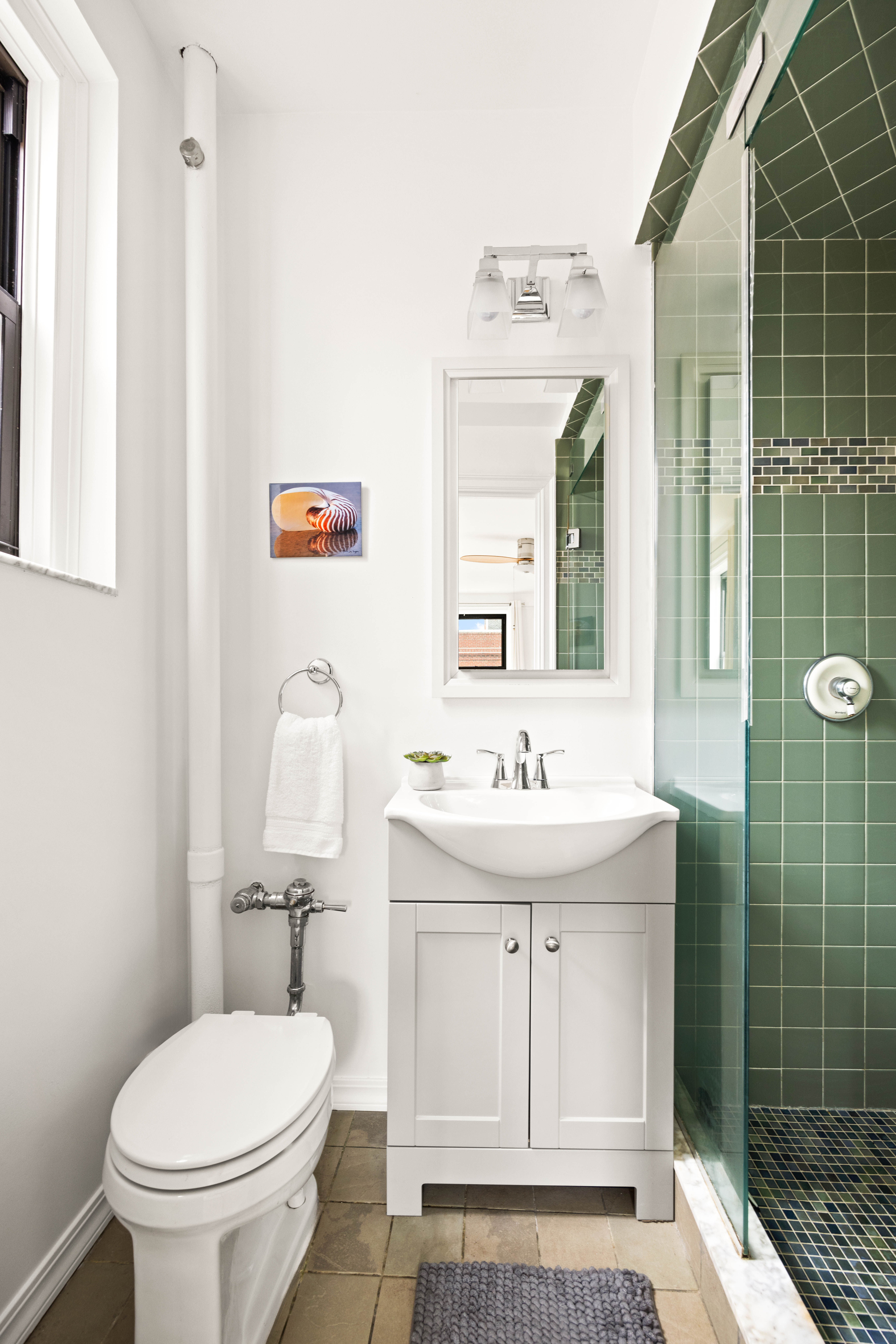 30 Ocean Parkway, Unit 6G Brooklyn, NY 11218 - Photo 13 of 18 a bathroom with a toilet a sink and shower