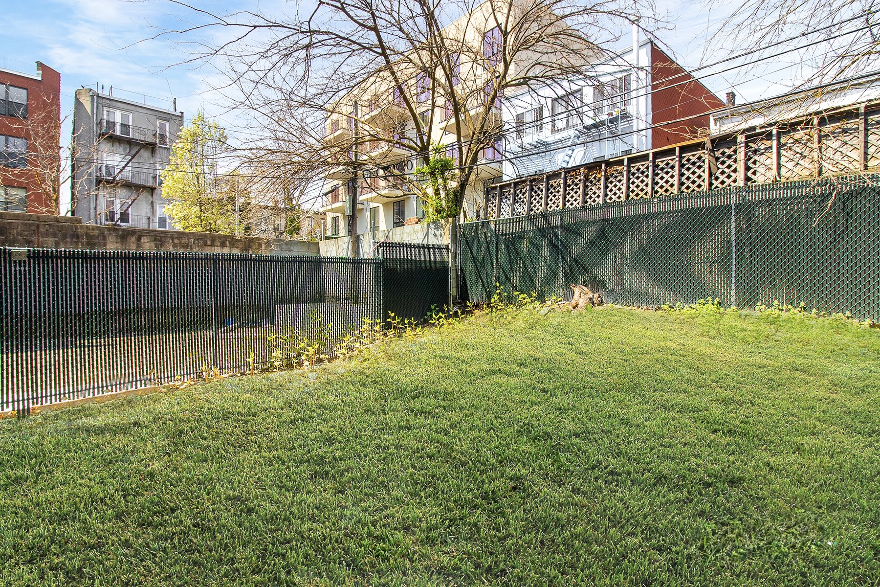1098 Madison Street, Unit 1B Brooklyn, NY 11221 - Photo 3 of 16 a backyard of a house with lots of green space and fountain