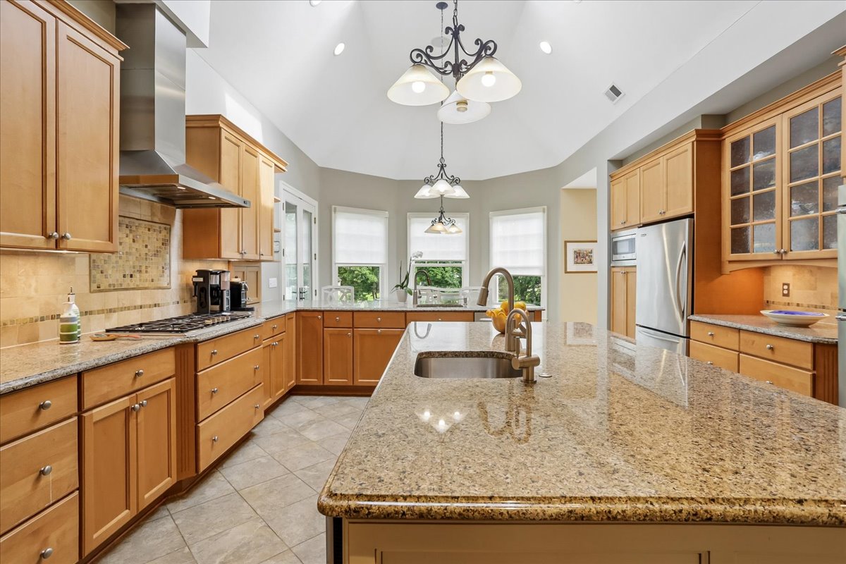11736 Gainsborough Road Potomac, MD 20854 - Photo 40 of 90 a kitchen with stainless steel appliances granite countertop a sink a stove and a wooden cabinets