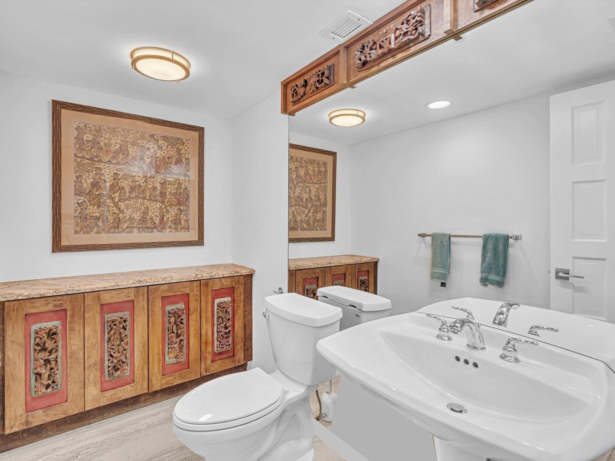 3000 South Ocean Boulevard, Unit 1504 Boca Raton, FL 33432 - Photo 21 of 64 a bathroom with a toilet a sink and a large mirror