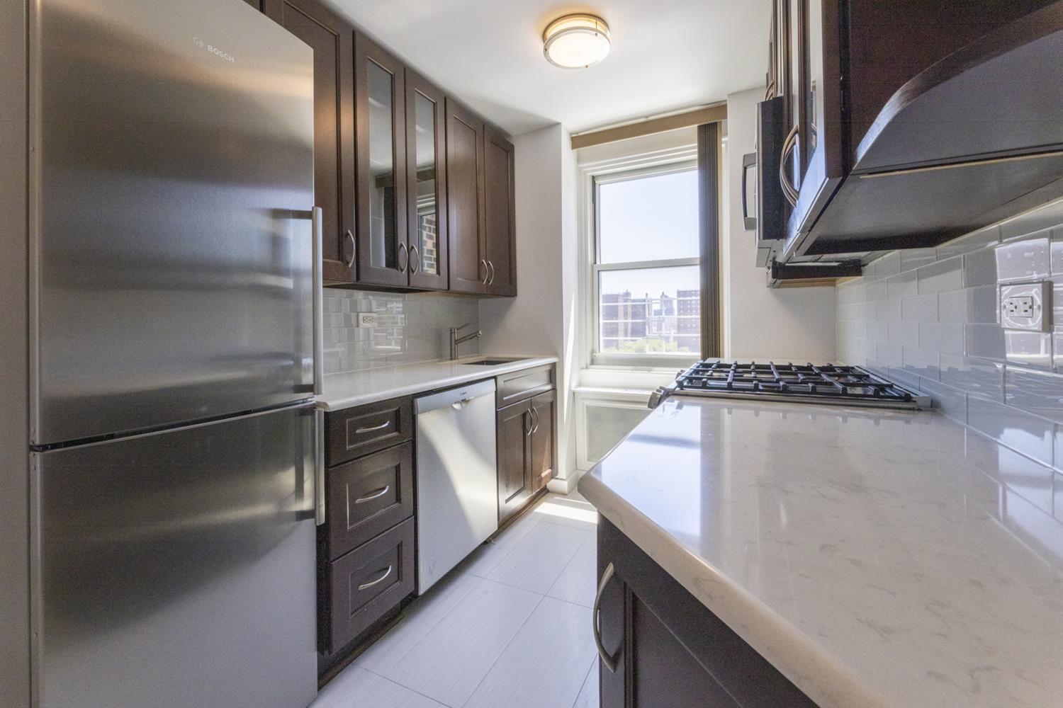 1270 5th Avenue, Unit 12C Manhattan, NY 10029 - Photo 6 of 18 a kitchen with a refrigerator and a sink
