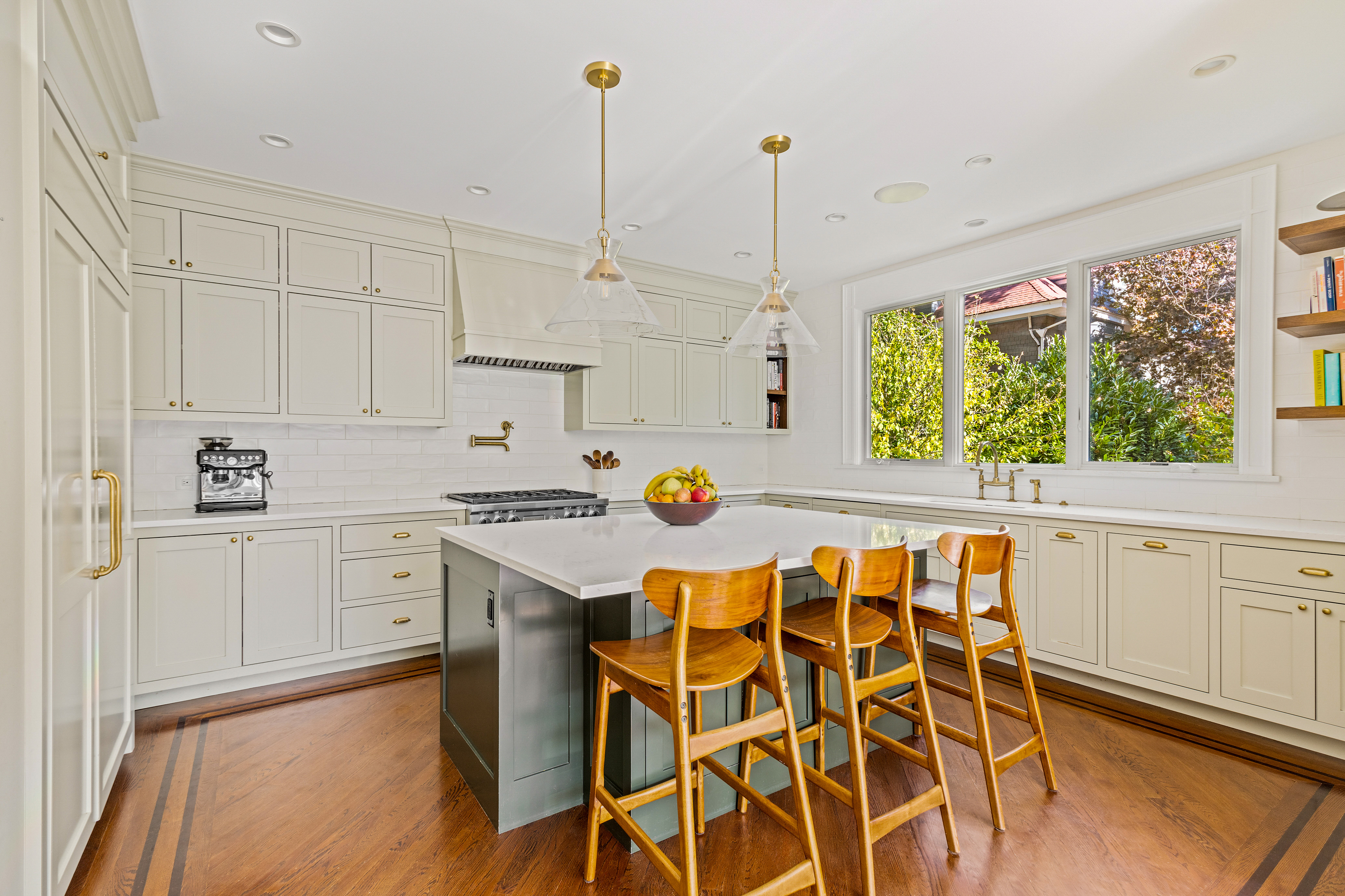 689 East 17th Street Brooklyn, NY 11230 - Photo 10 of 28 a kitchen with a stove a sink and white cabinets with wooden floors