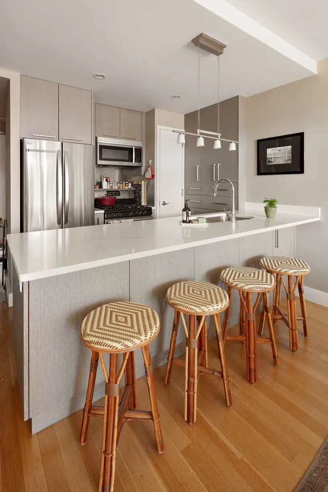 a kitchen with stainless steel appliances granite countertop a table chairs sink and cabinets