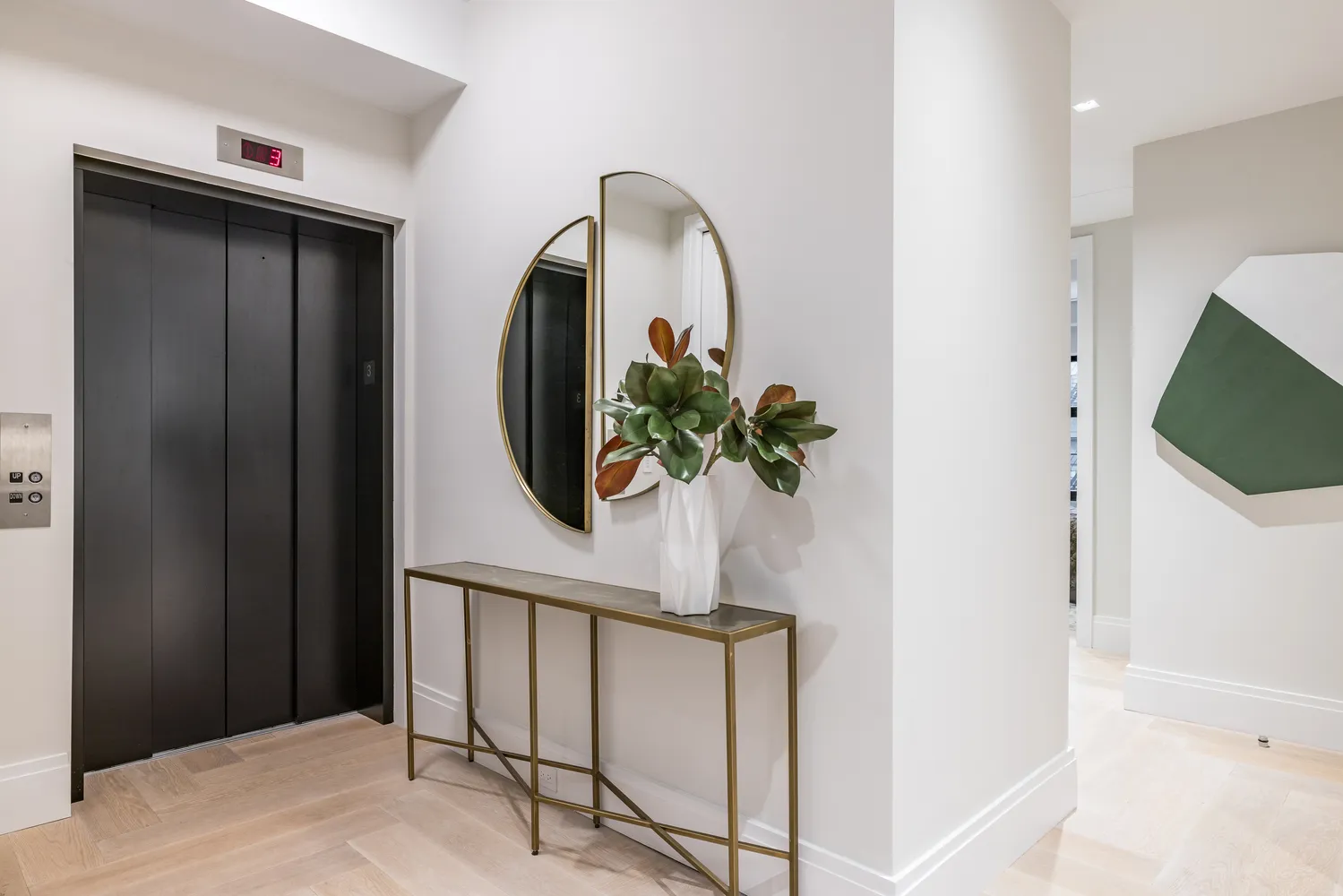 a vase of flowers sitting on a table near a hallway